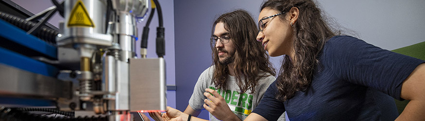 photo of two students working in a lab