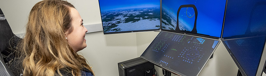 photo of a student looking at monitors