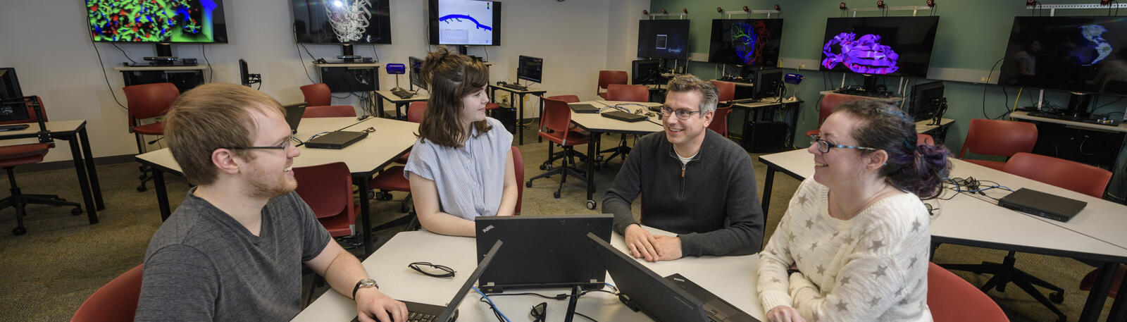 photo of students and a professor in a lab