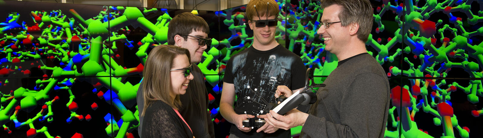 photo of students and a professor in a lab